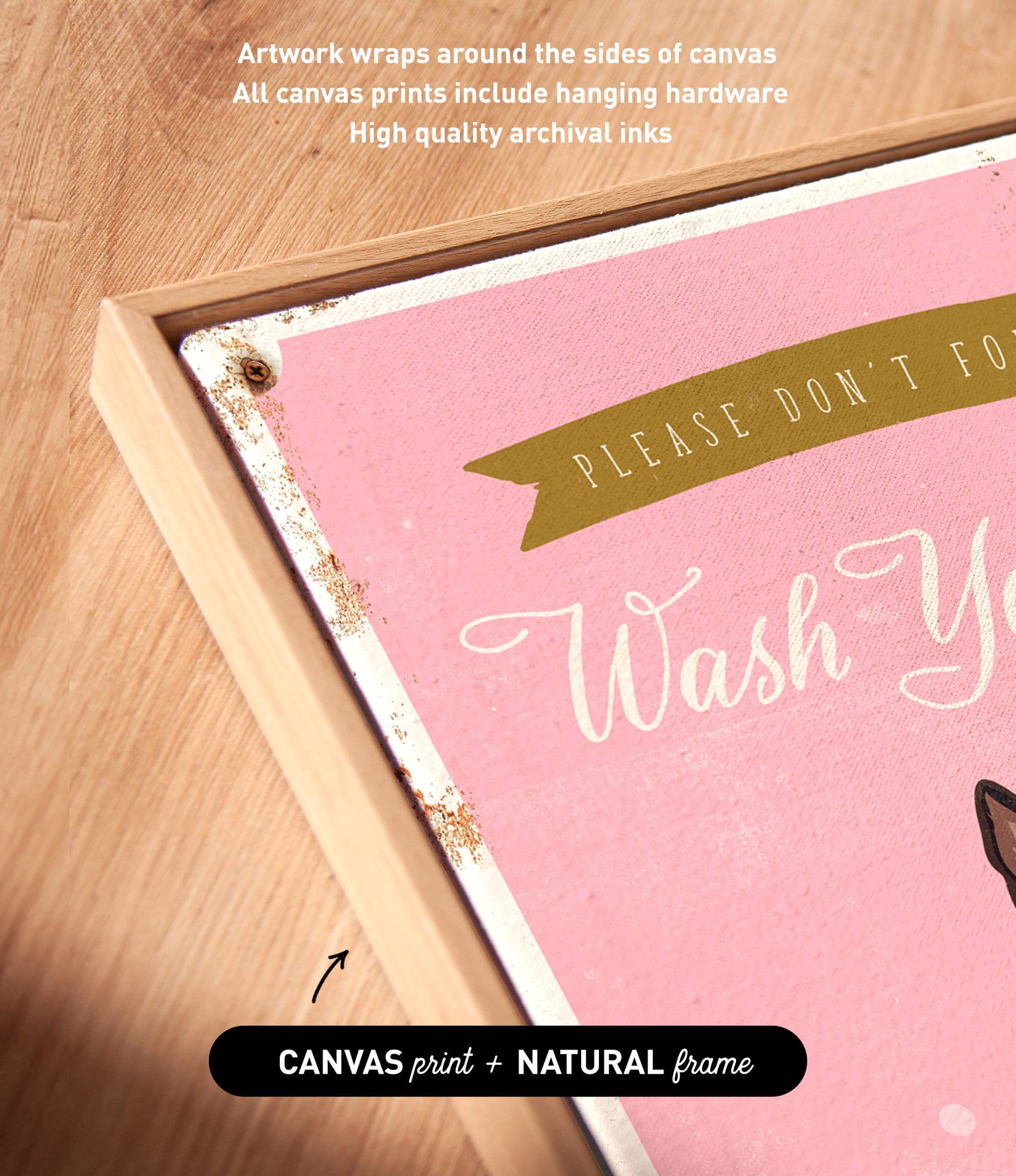 a pink canvas with the text "Please don't forget to wash your hands" written on it. The canvas is framed in a natural frame, and there is a small arrow pointing to the bottom right corner of the canvas.