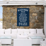 a white couch sitting next to a stone wall