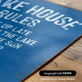 a close-up of a blue sign with white text, placed on a wooden surface.