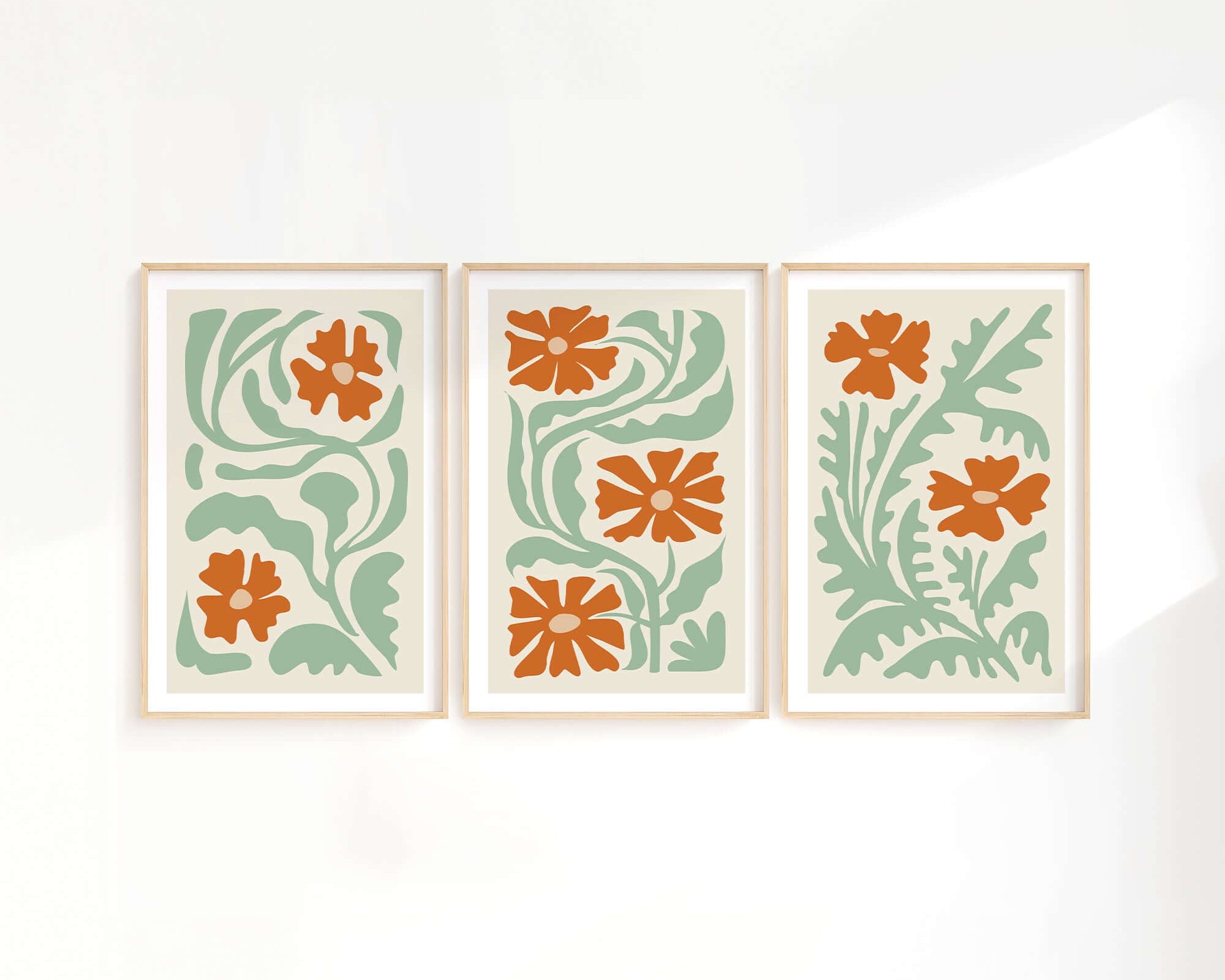 The Flower Blocks Triptych | Set of Three Prints | 013 features three framed abstract floral prints with orange flowers and green leaves—ideal wall art for modern home decor.