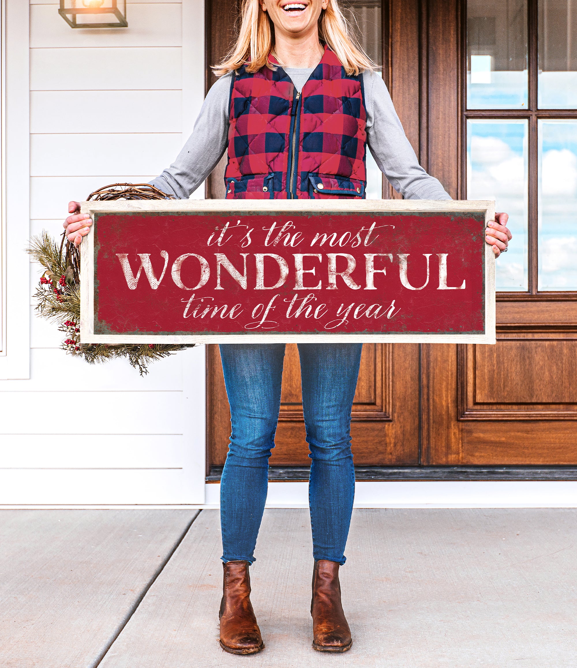 a woman holding a sign that says it's the most wonderful time of the