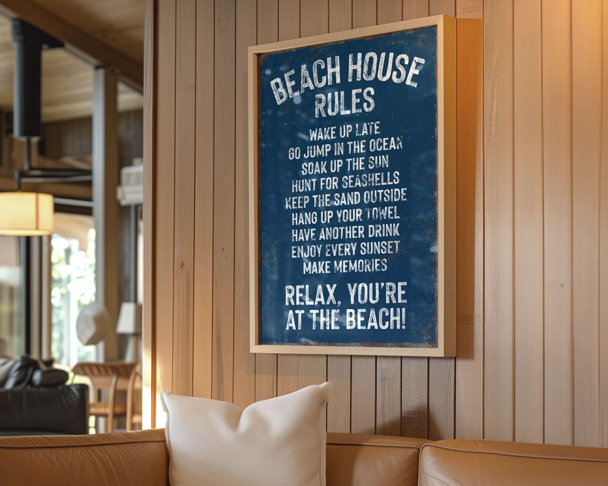 A modern farmhouse living room features a cozy wooden wall adorned with the Beach House Rules Sign, Rusted Edge, Nautical—perfect for stylish home wall decor.