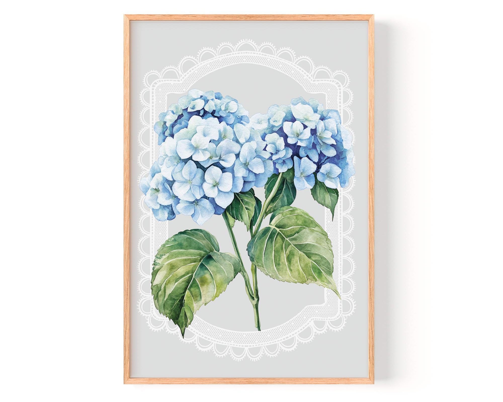 A framed print of a watercolor painting depicting a cluster of blue hydrangea flowers with green leaves.