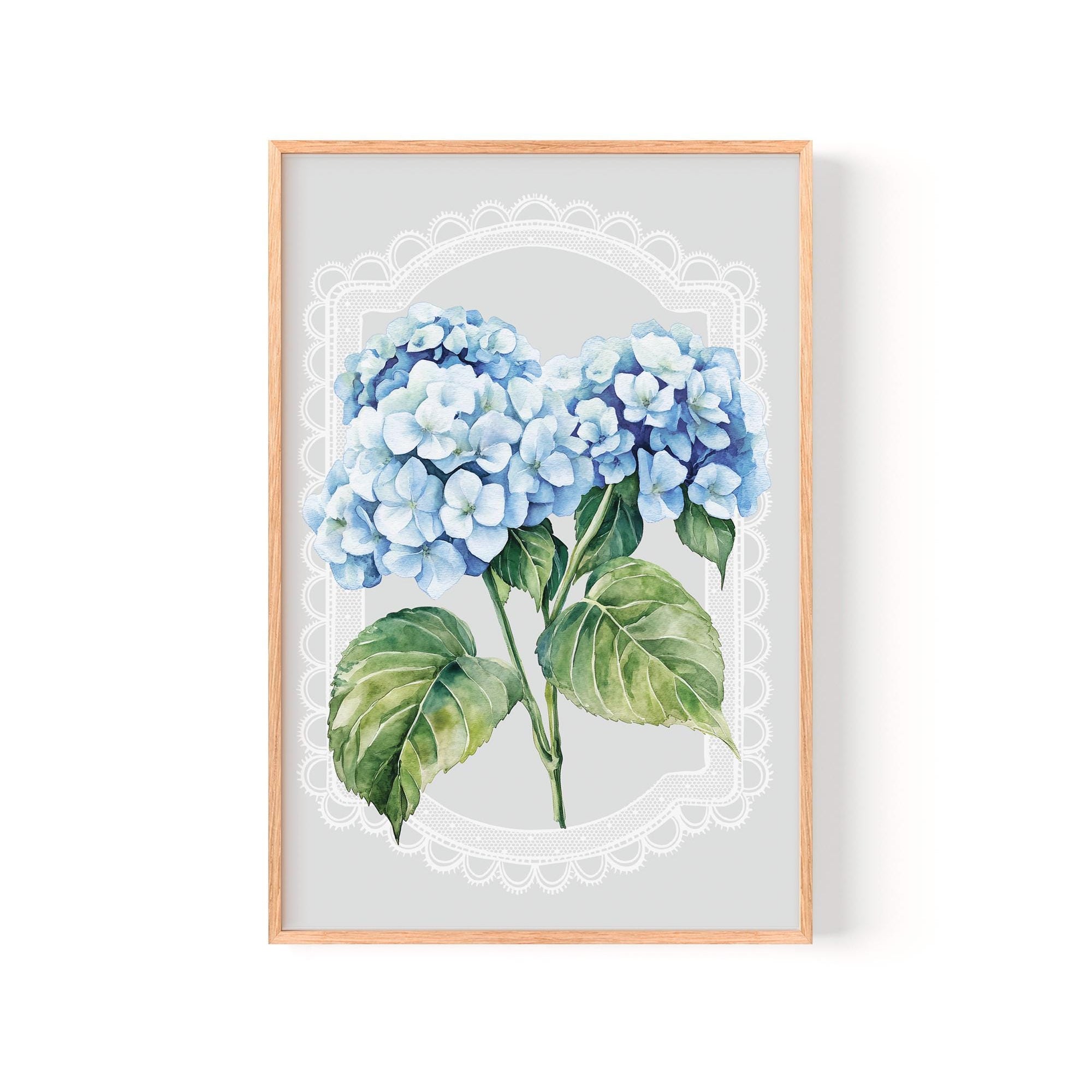 A framed print of a watercolor painting depicting a cluster of blue hydrangea flowers with green leaves.