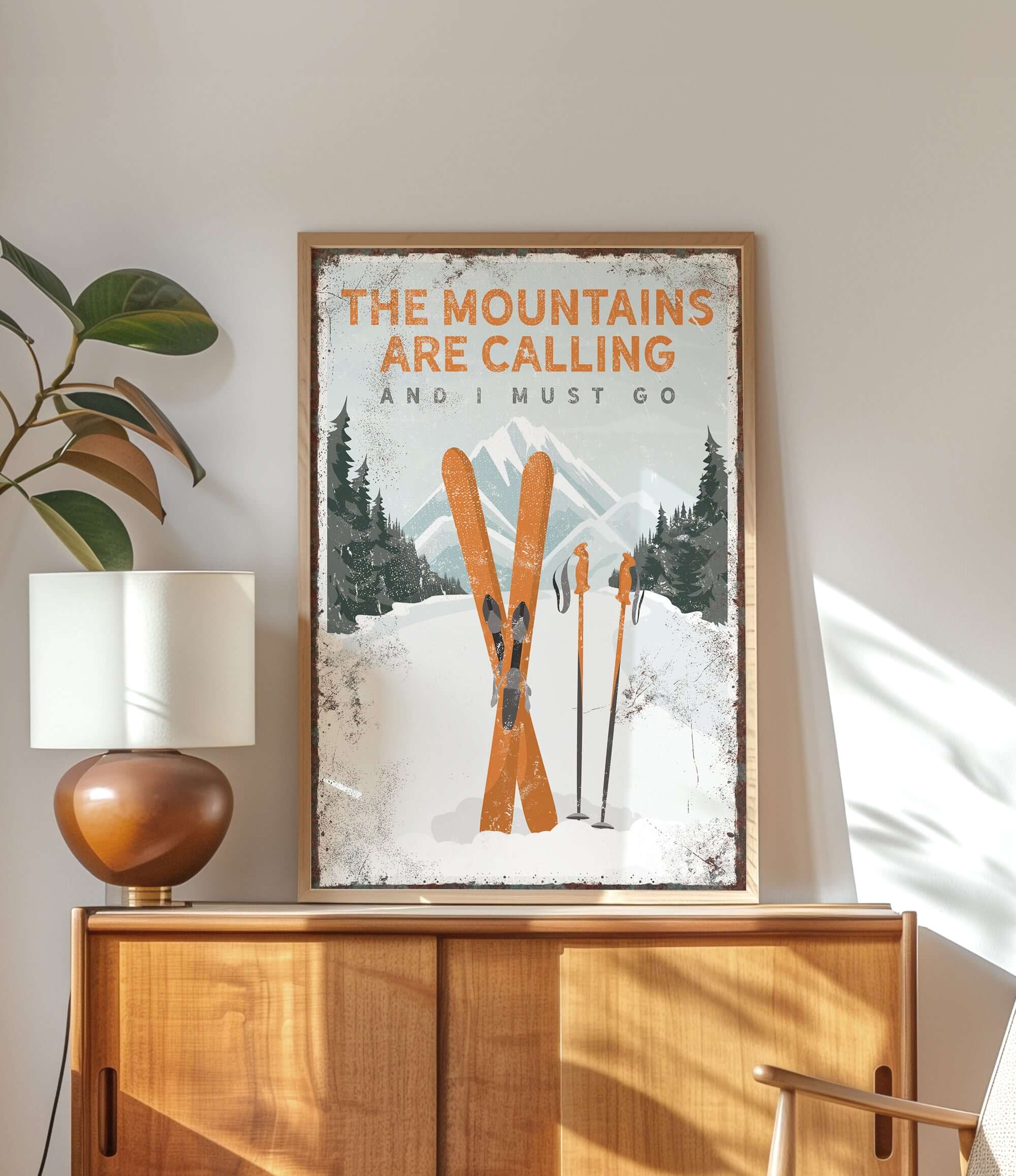 a poster of skis on a dresser next to a lamp