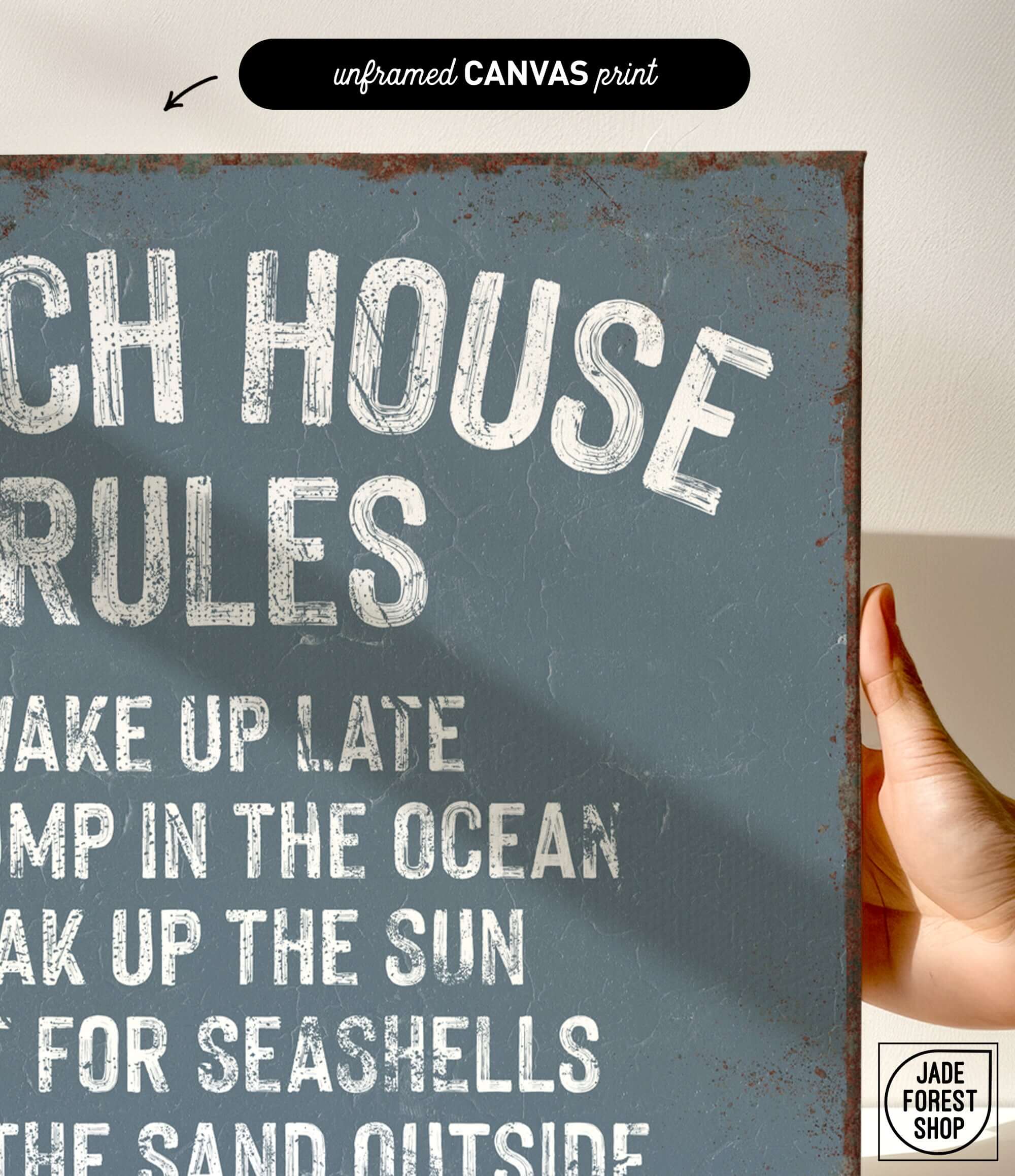 a hand holding a sign that says beach house rules