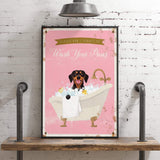 A framed poster with a dog sitting in a bathtub filled with bubbles, accompanied by the text "Please don't forget to wash your paws".