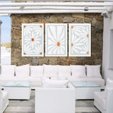a living room filled with white furniture and a stone wall