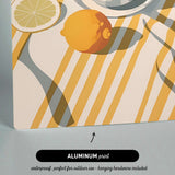 The image is an aluminum print featuring a lemon and a slice of orange on a striped background.