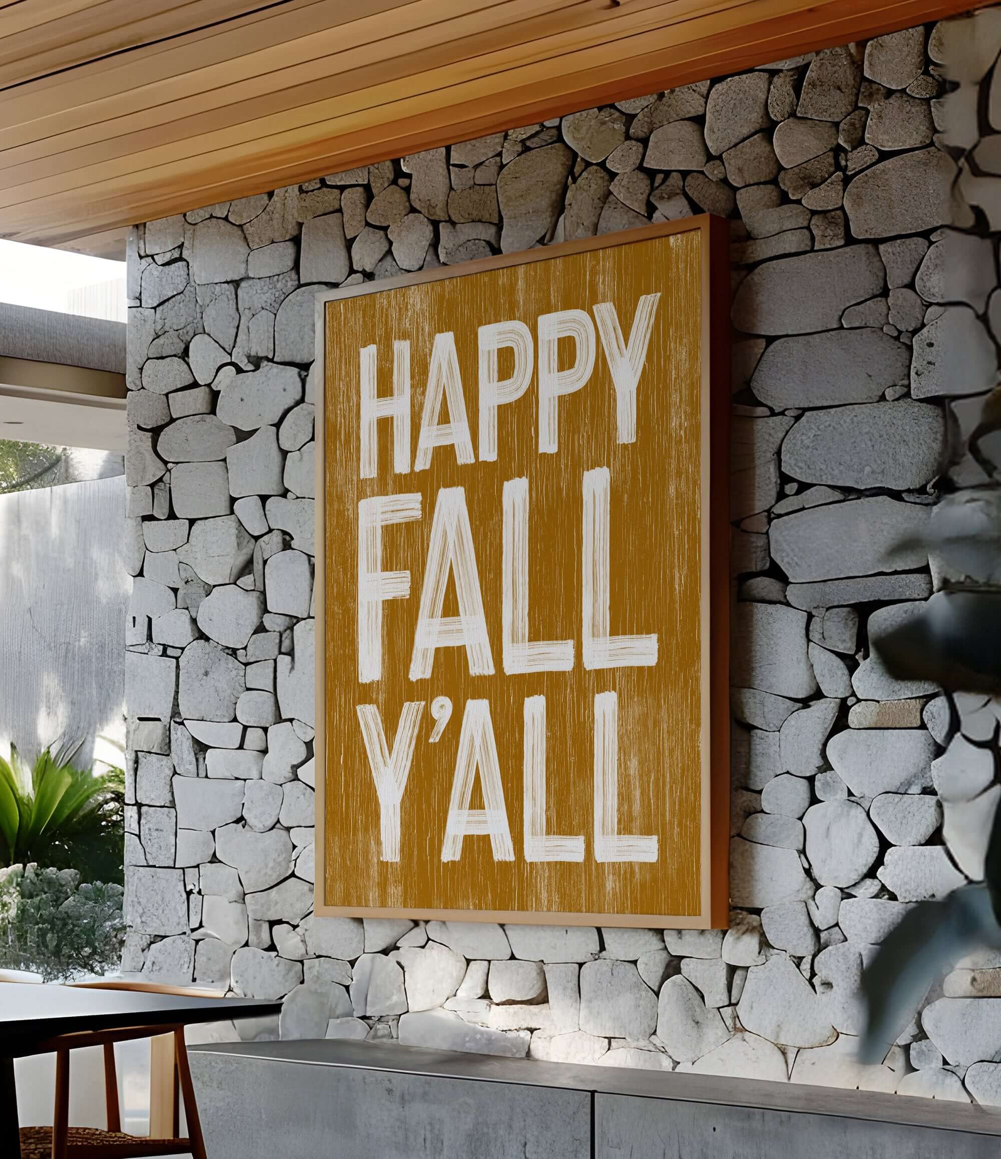 a sign that says happy fall y'all on a stone wall