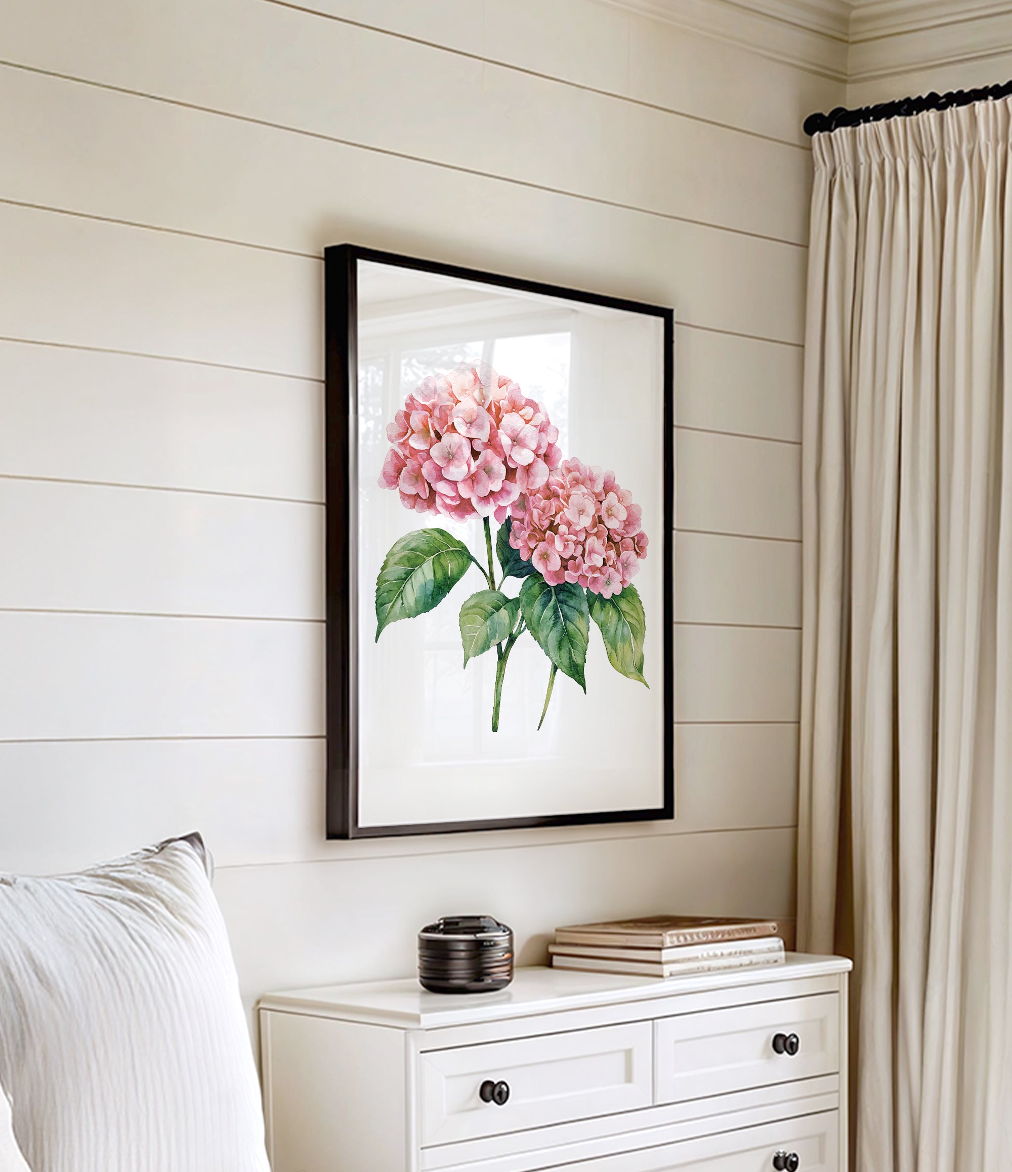 a white dresser with a framed picture of pink flowers hanging on the wall above it.