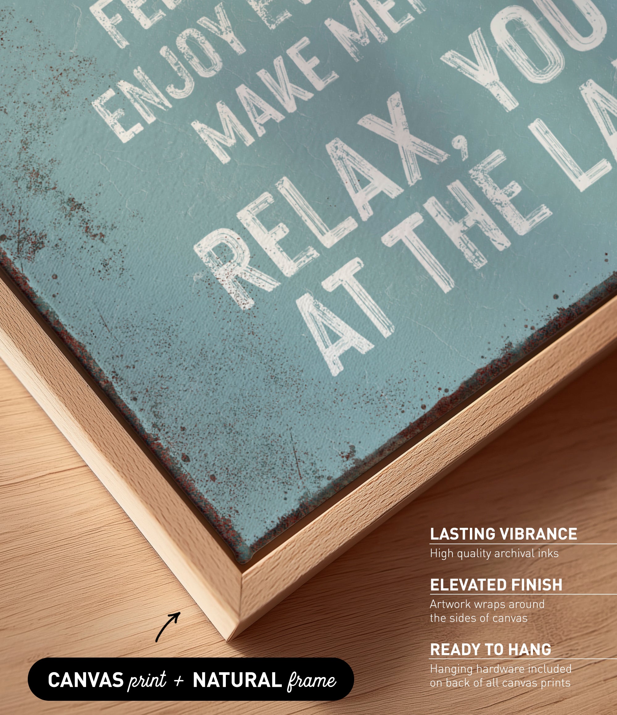 a close-up view of a textured, weathered canvas print with a wooden frame. The text on the canvas is in white and reads "Enjoy life, make memories, relax at the lake".