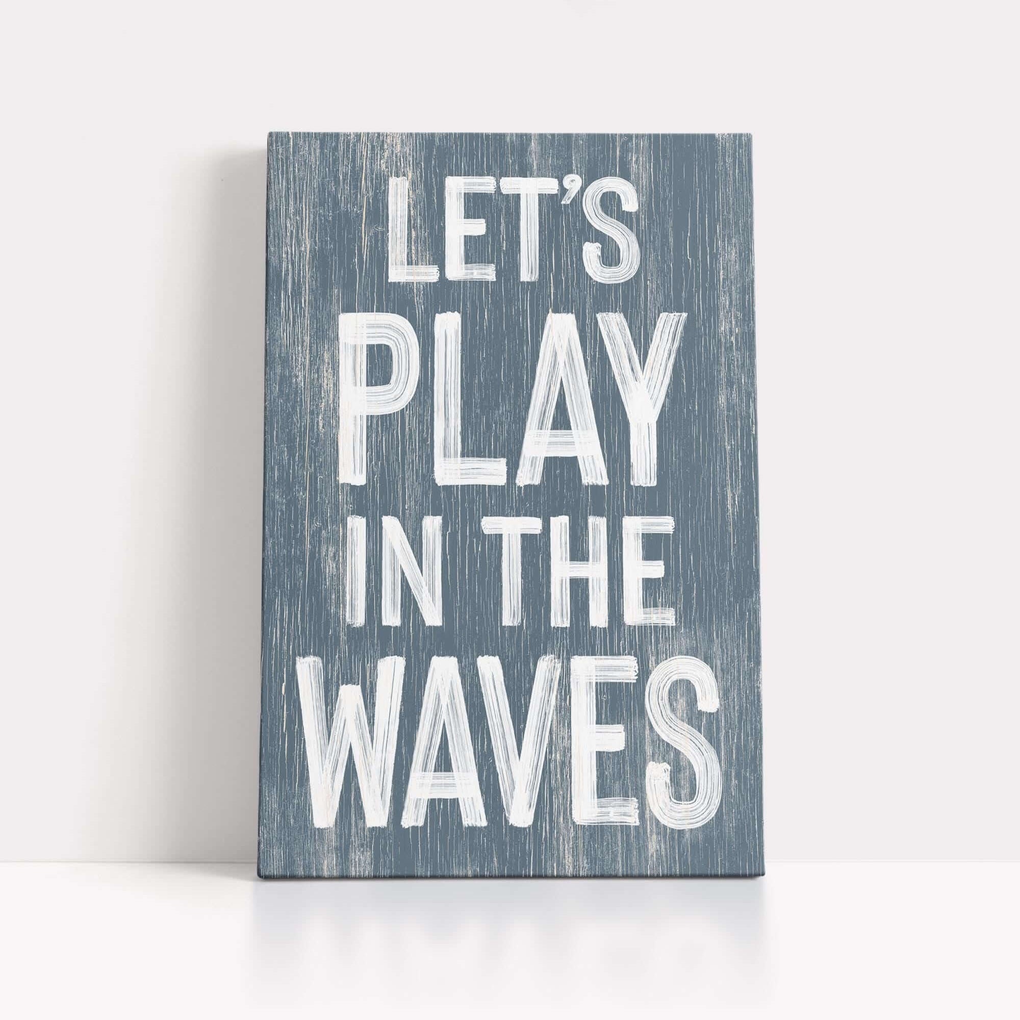 a wooden sign that says let's play in the waves