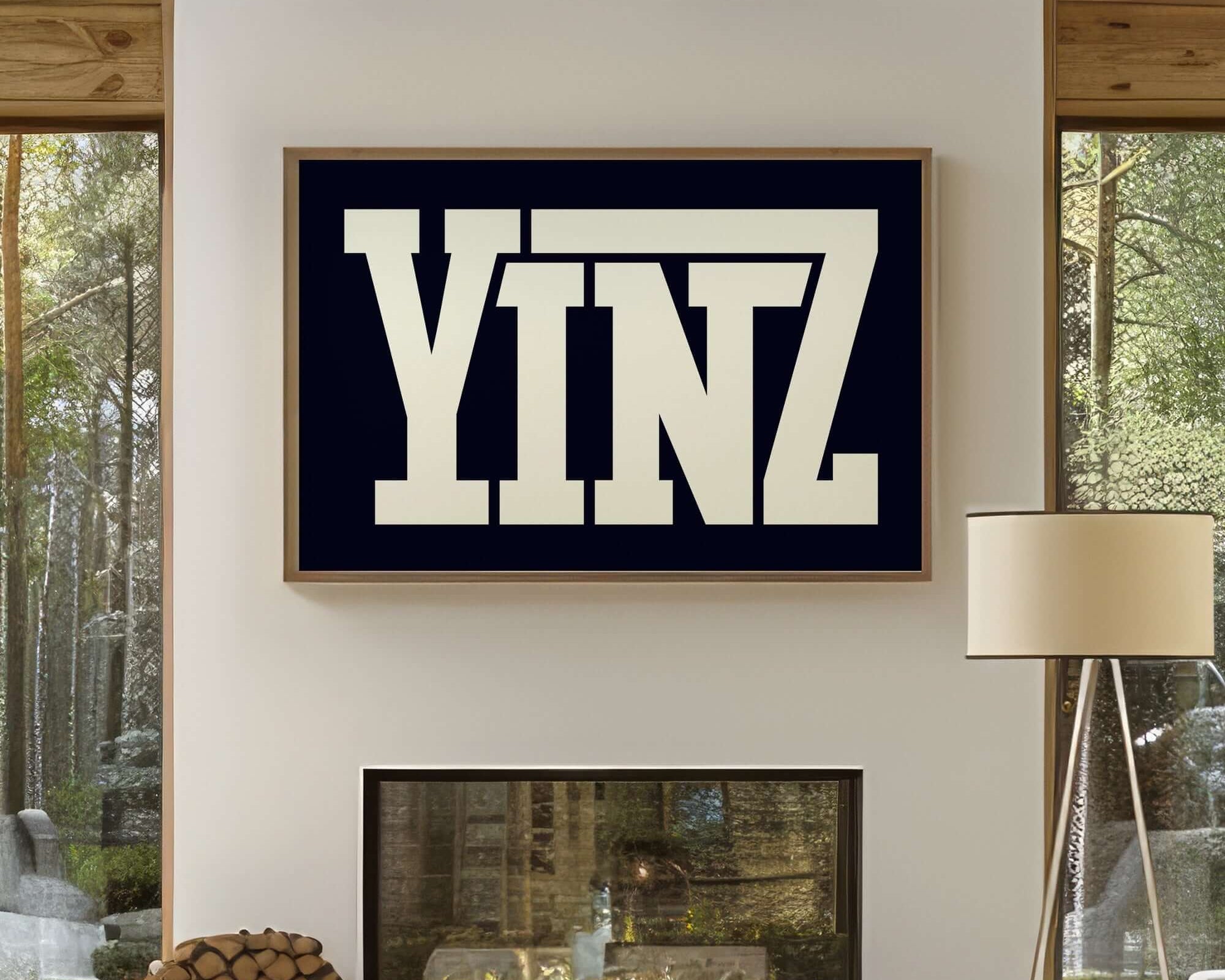 A Yinz Sign Print in black hangs above a modern fireplace, bringing unique home decor and modern farmhouse charm to the bright room with large windows.
