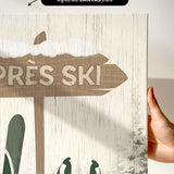 a hand holding a sign that says tres ski