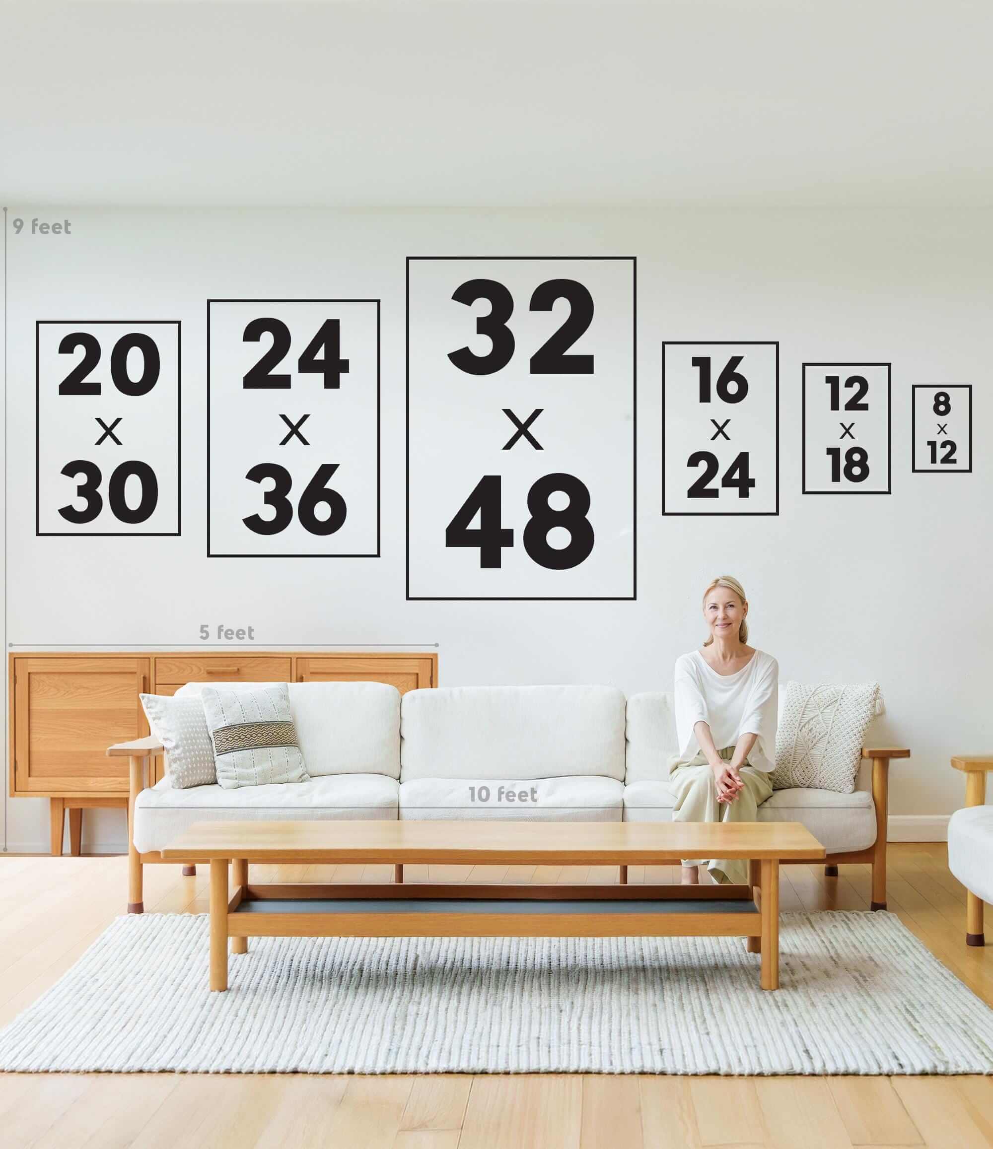 A woman sits on a sofa in a modern living room with various framed print sizes on the wall, including the Après Ski Lift Couple Wall Art, Black Print.