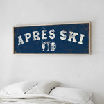 a bedroom with a bed and a framed sign that reads "APRES SKI" above it.