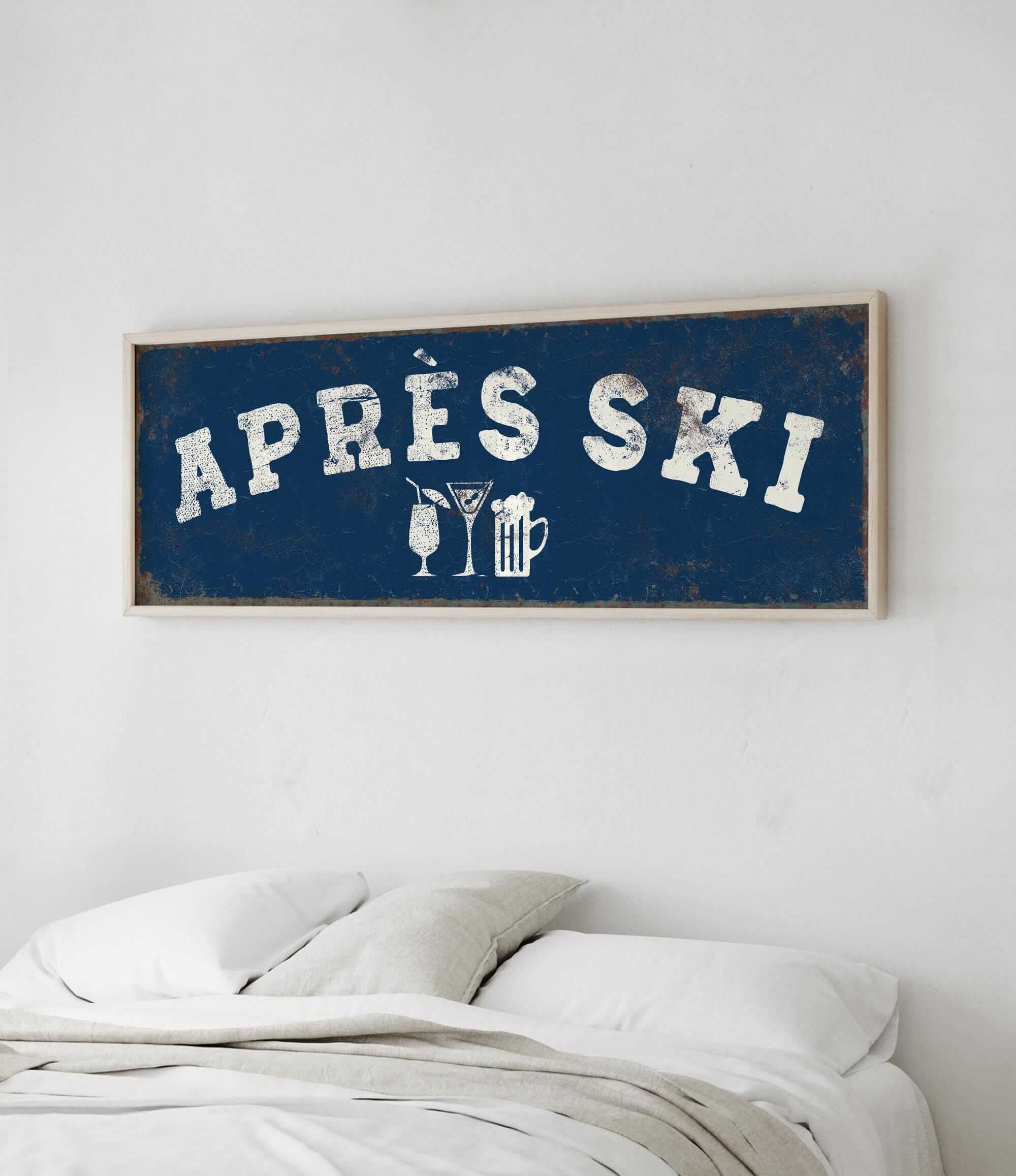 a bedroom with a bed and a framed sign that reads "APRES SKI" above it.