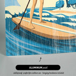 The image is an illustration of a woman paddleboarding on a body of water, with a text overlay that reads "ALUMINUM print" and "waterproof, perfect for outdoor use - hanging hardware included".