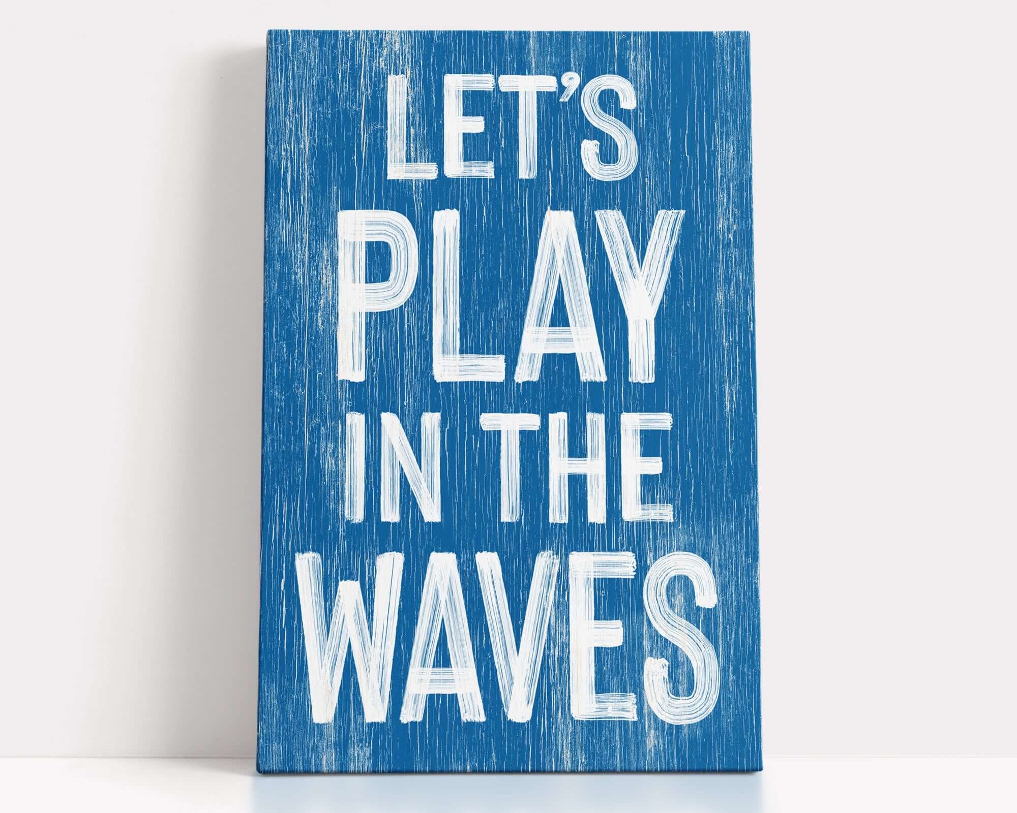 A blue sign with the text "LET'S PLAY IN THE WAVE" written in white lettering.