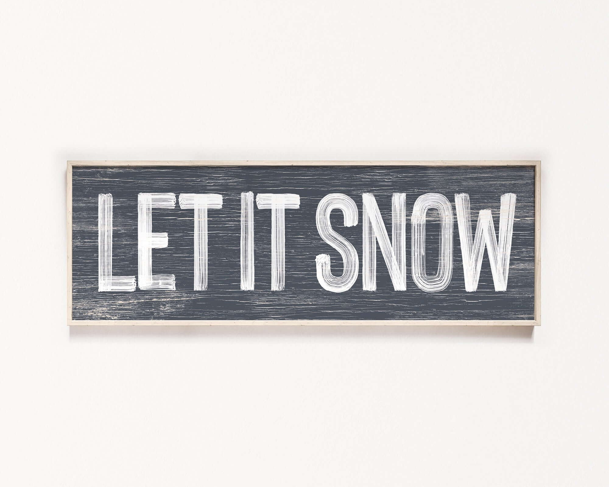 a wooden sign that says let it snow