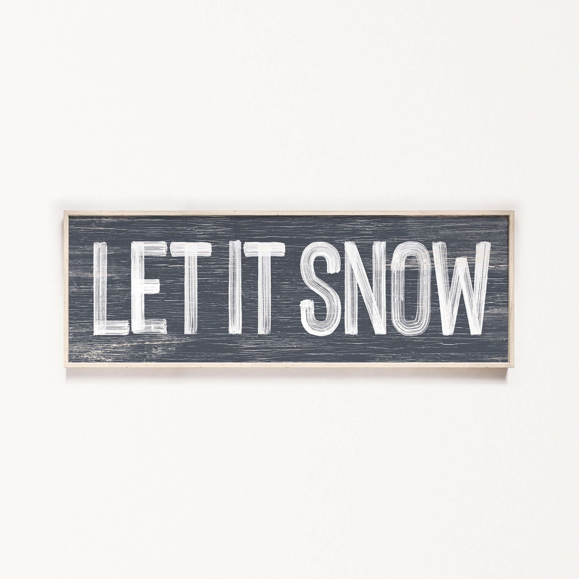 a wooden sign that says let it snow
