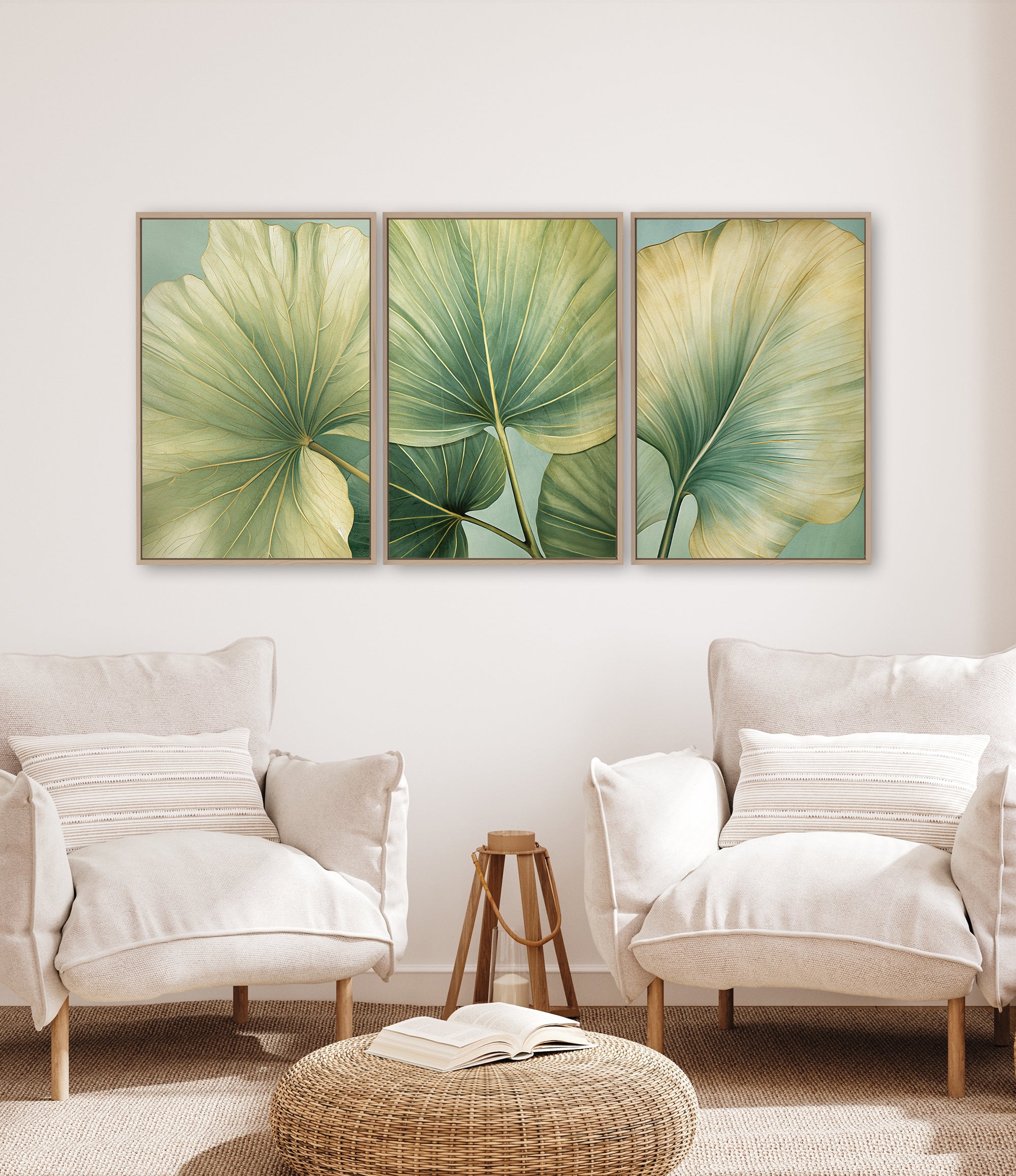 three large framed prints of green leaves hanging on a wall in a living room setting.