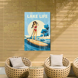 a woman paddleboarding on a lake, with a sign above her that says "LAKELIFE". The scene is set against a wooden wall with wicker furniture, including two chairs and a small table.