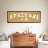 a wooden dresser with a framed sign above it that says "APRÈS SKI", and there are two white chairs and a vase with flowers on the dresser.