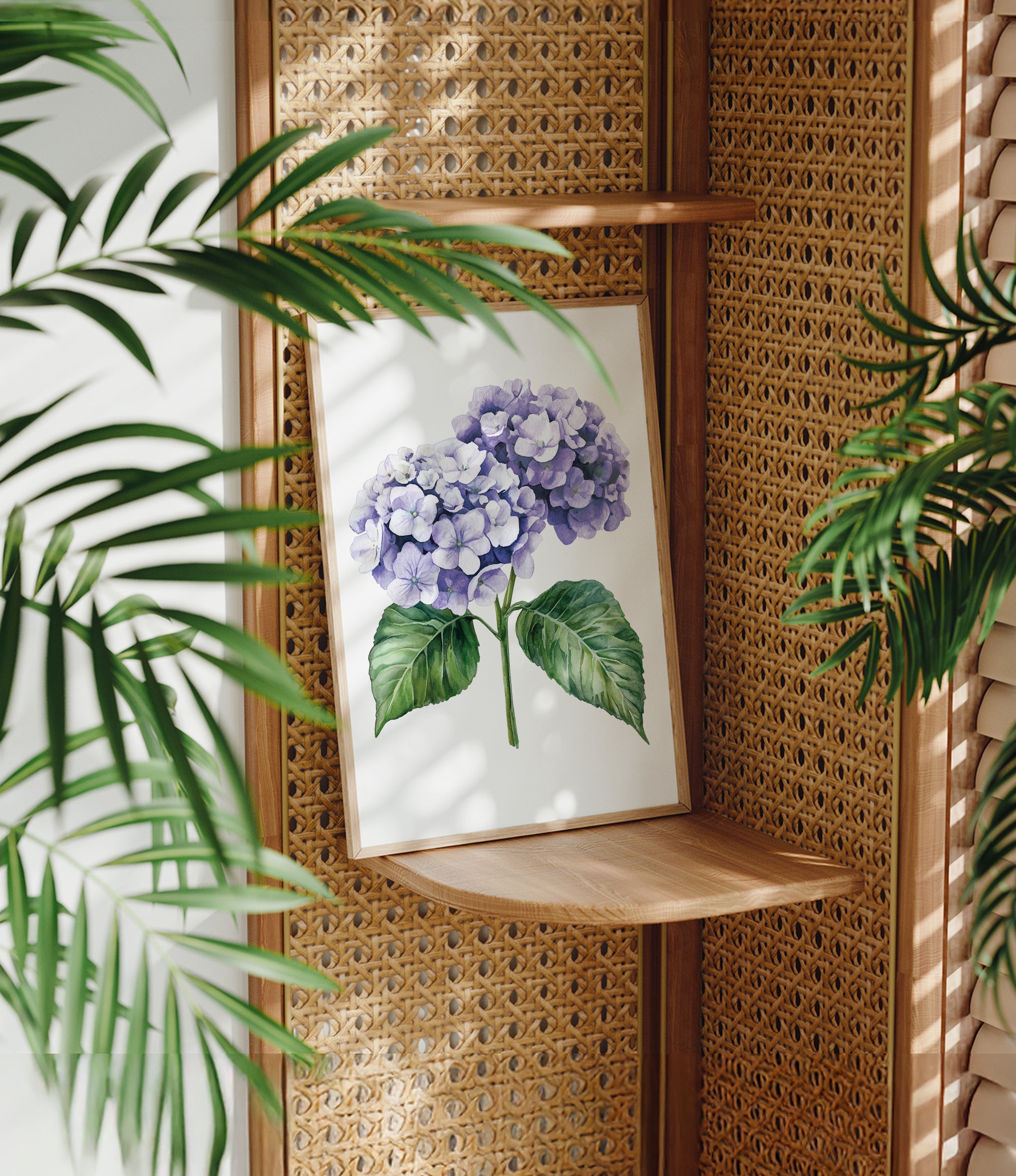 a framed painting of a purple hydrangea flower on a wooden shelf, surrounded by lush green leaves.