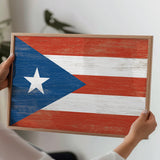 a person holding a wooden sign with a flag painted on it