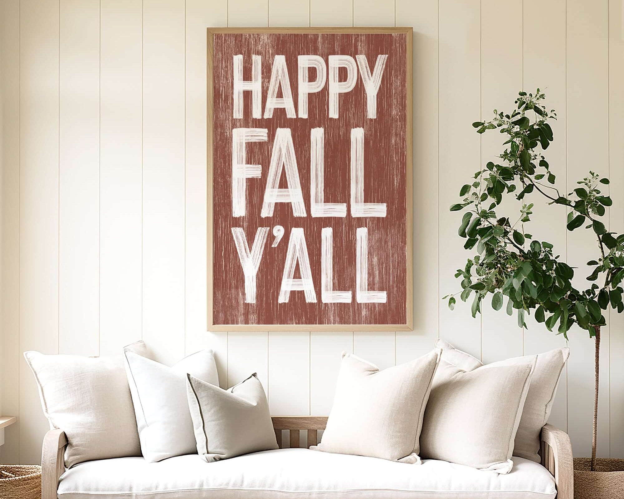 a living room with a couch and a happy fall y'all sign