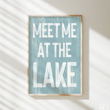 a blue and white sign that says meet me at the lake