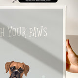 a brown dog with a friendly expression, sitting next to a gray background with the text "Witch Your Paws" written on it.