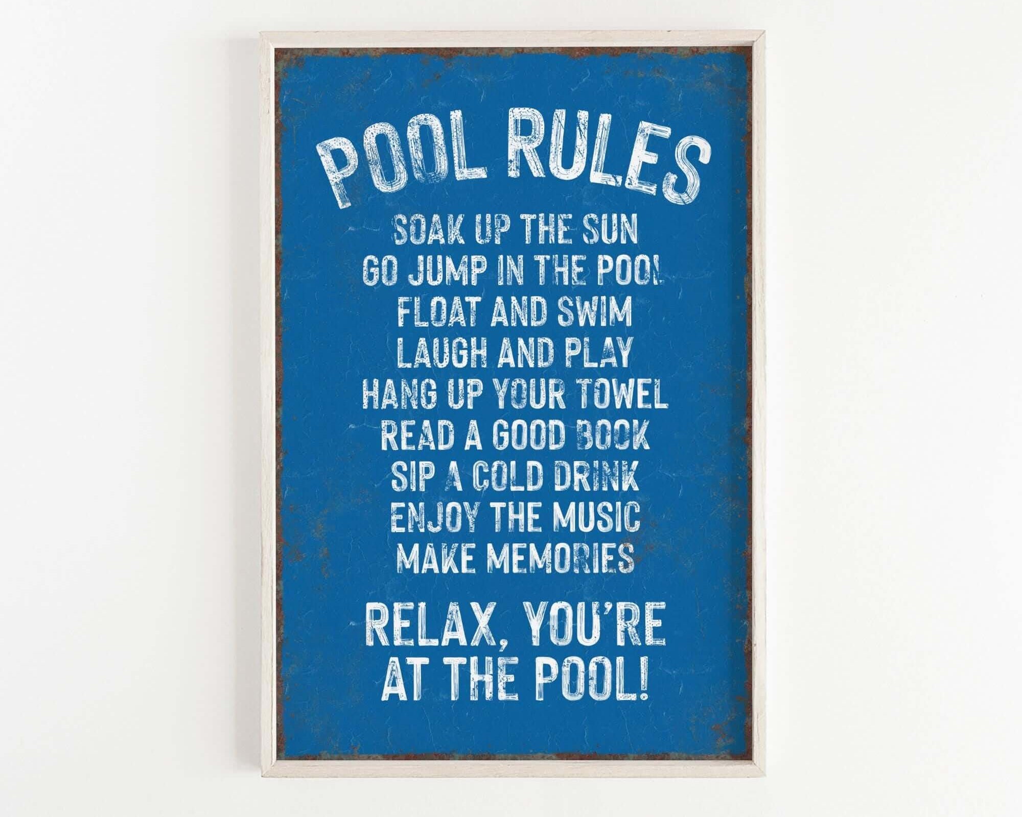 a picture of a pool rules sign hanging on a wall