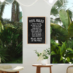 a room with a potted plant and a sign on the wall
