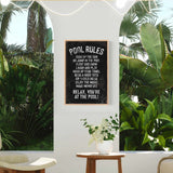 a room with a potted plant and a sign on the wall