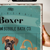 a hand holding a framed print with a vintage-style illustration of a boxer dog.