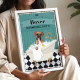 A woman is holding a framed picture of a dog in a bathtub, with a sign that reads "Boxer SOAP & BUBBLE BATH CO."