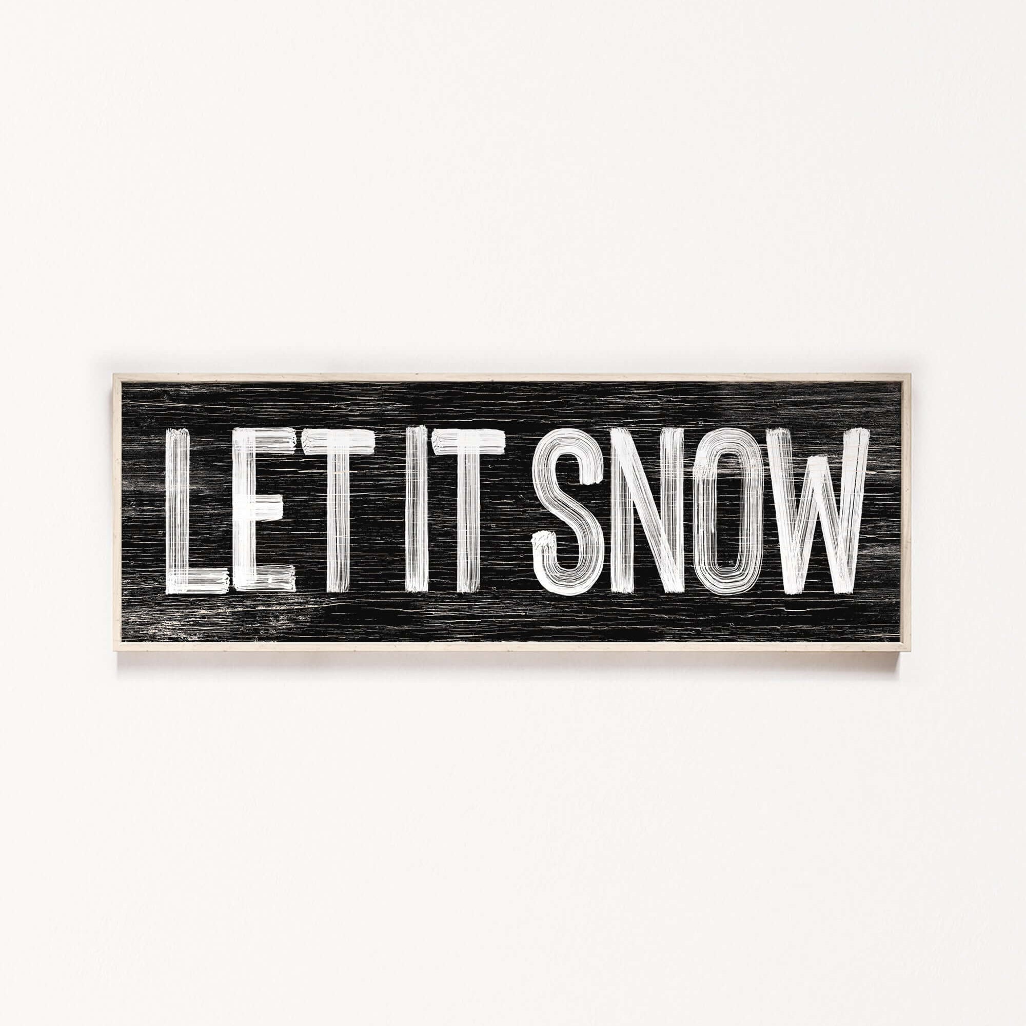 a wooden sign that says let it snow