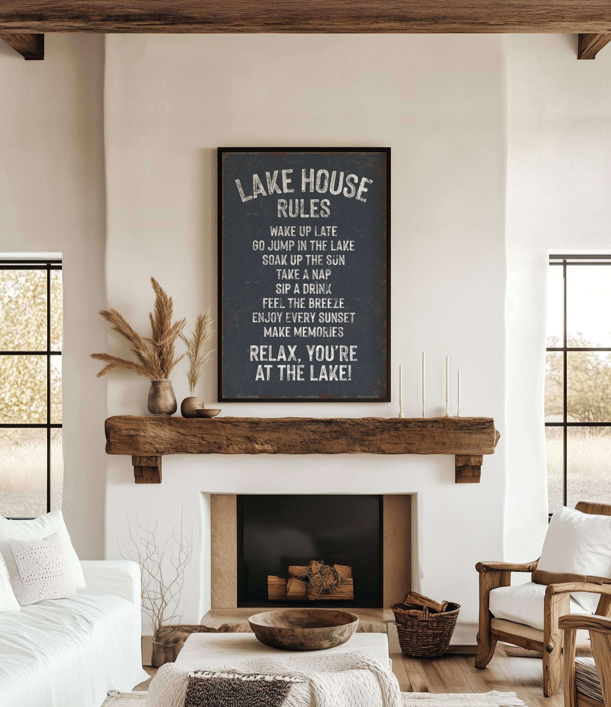a cozy living room with a fireplace, a wooden mantel, and a framed sign that reads "Lake House Rules" above the fireplace.