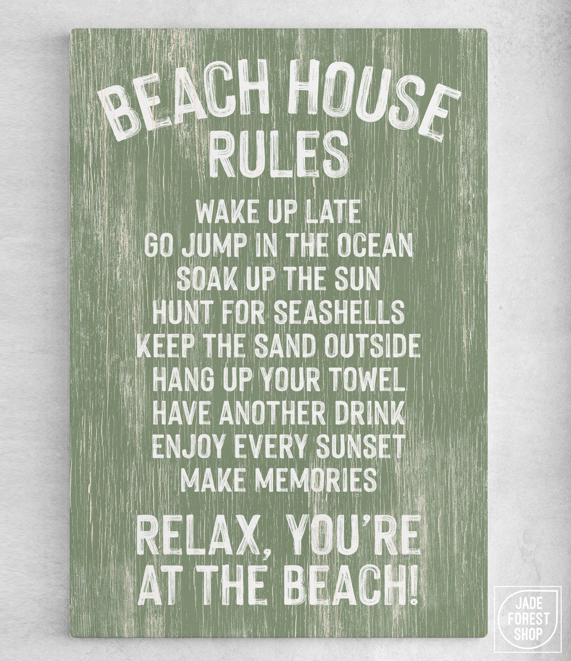 The Beach House Rules Sign is a green seagrass-painted wooden sign with white text—“Relax, you’re at the beach!”—making it perfect coastal wall art for your seaside retreat.
