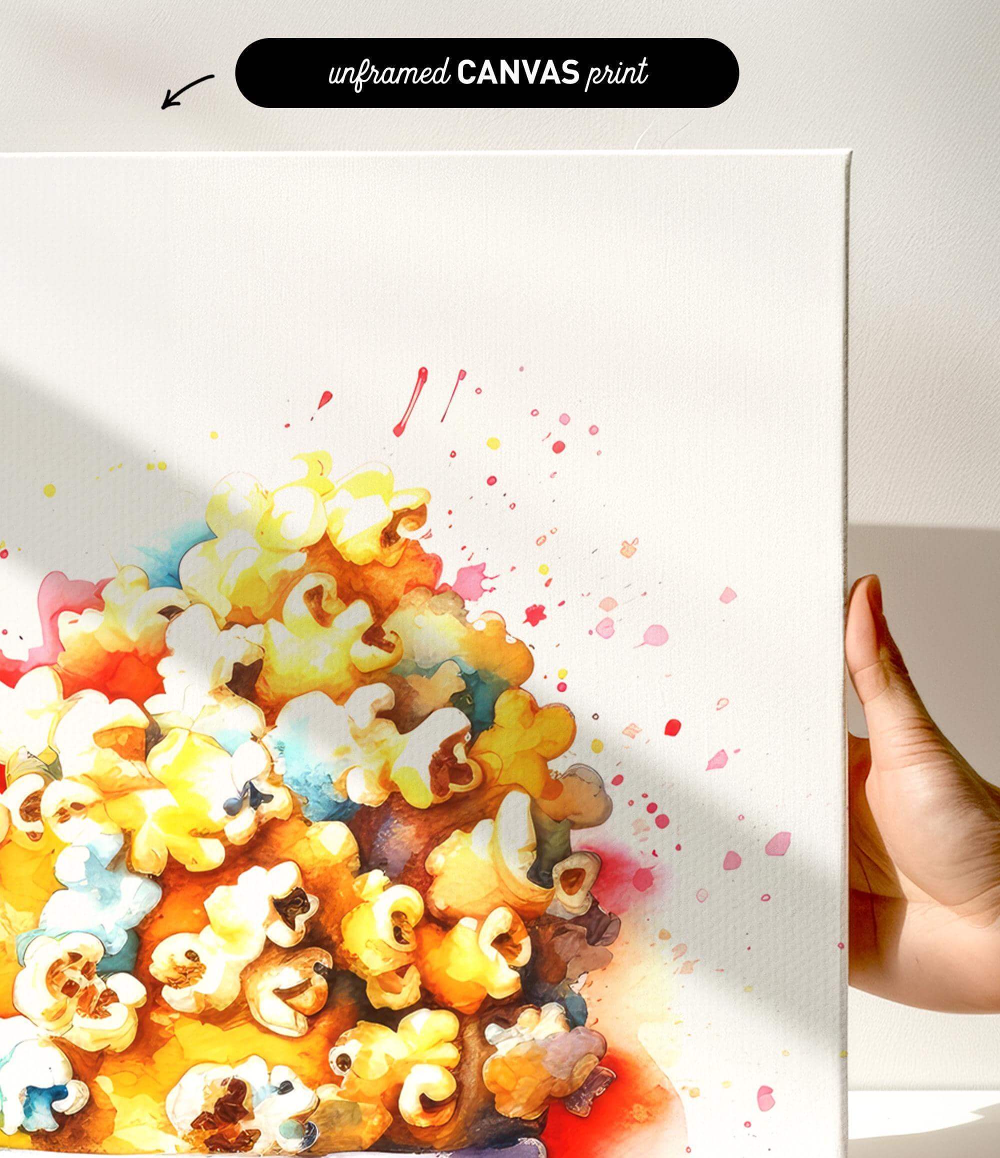 The image is a watercolor painting of a pile of popcorn, with splashes of color and a hand holding the canvas.