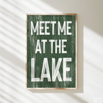 a green sign that says meet me at the lake