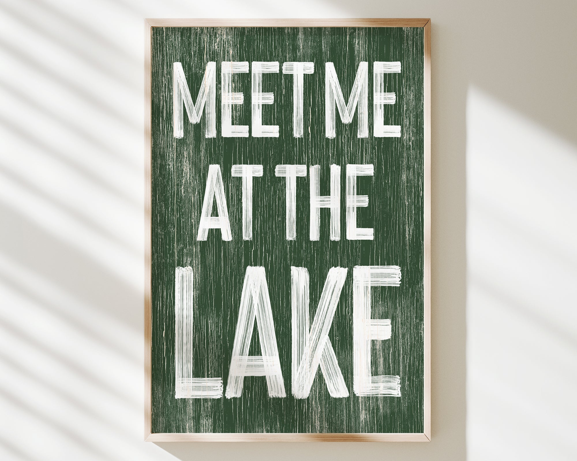 a green sign that says meet me at the lake
