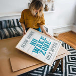 a woman holding a sign on top of a table