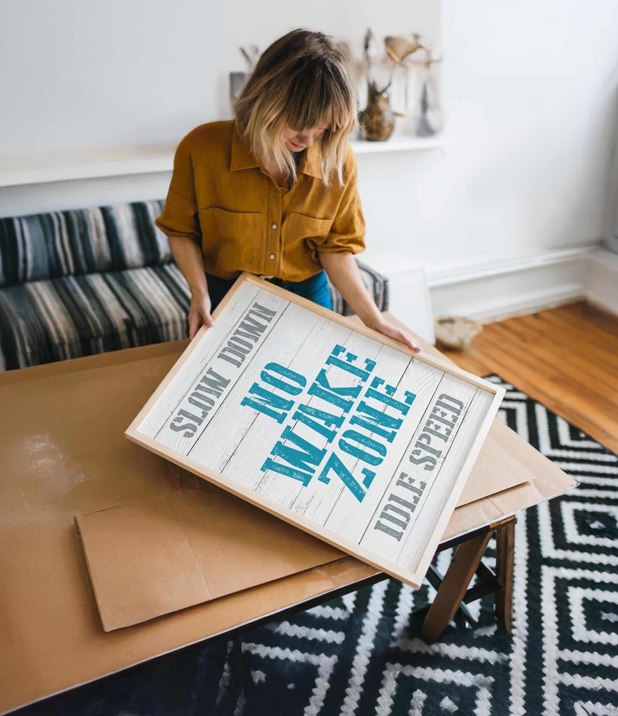 a woman holding a sign on top of a table