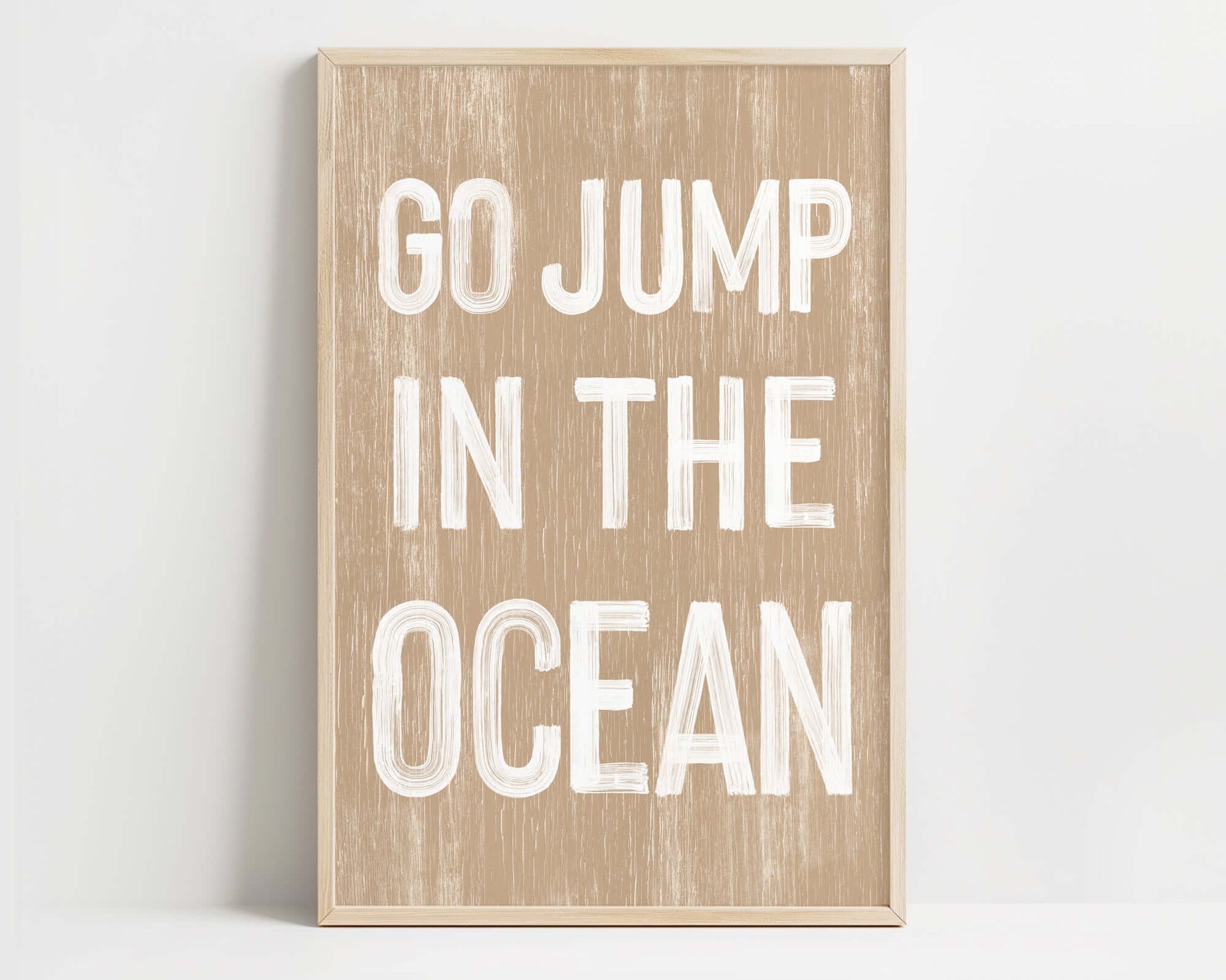 a wooden sign that says go jump in the ocean