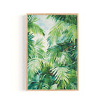 The image is a framed painting depicting a lush, tropical scene with vibrant green palm leaves and other tropical foliage.