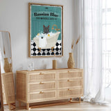 a poster of a cat in a bathtub, with the text "Russian Blue SOAP & BUBBLE BATH CO." The poster is hanging on a wall above a wooden dresser with drawers.